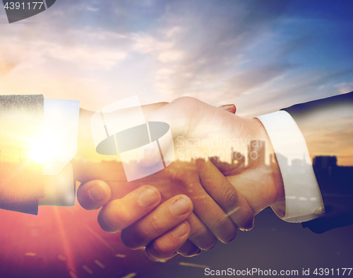 Image of businessman and businesswoman shaking hands