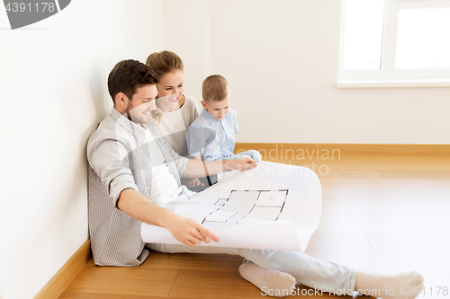 Image of happy family with blueprint moving to new home