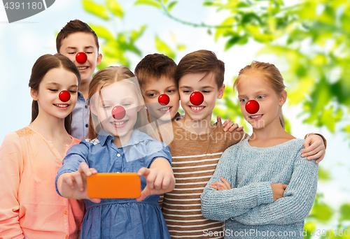 Image of kids taking selfie with smartphone at red nose day