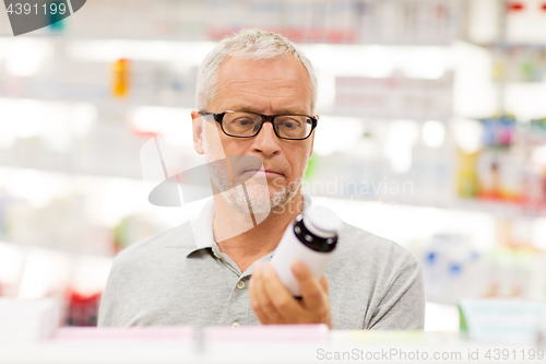 Image of senior male customer with drug at pharmacy