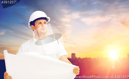 Image of male builder in white hard hat with blueprint