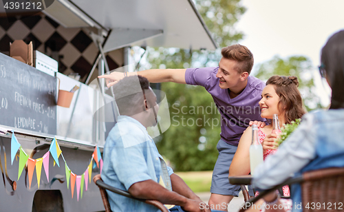 Image of happy customers or friends at food truck