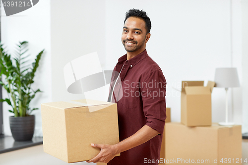 Image of happy man with box moving to new home