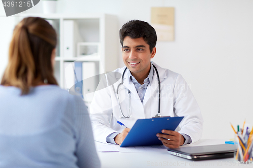 Image of doctor with clipboard and patient at hospital