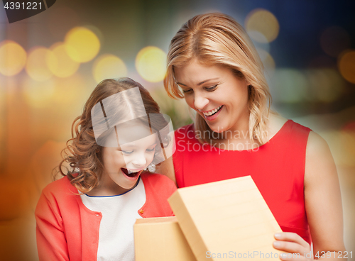 Image of happy mother and daughter with gift box