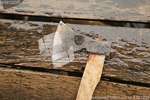 Image of Axe on wet planks