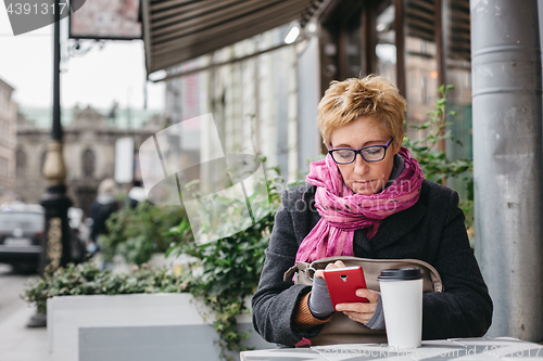 Image of Adult woman surfing phone