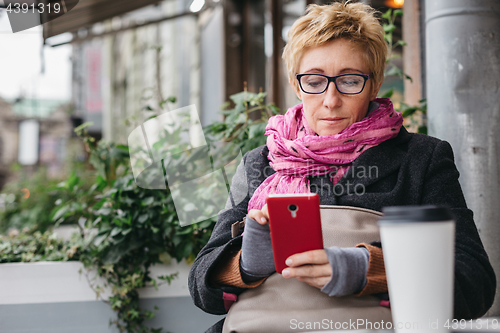 Image of Adult woman surfing phone