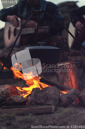 Image of guitar near the campfire