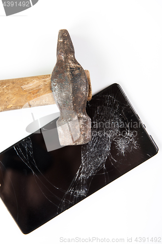 Image of An old hammer and smartphone