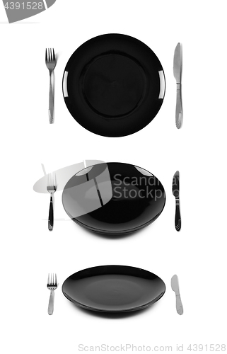 Image of Black plate with fork and knife.
