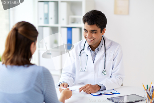 Image of doctor giving prescription to patient at hospital