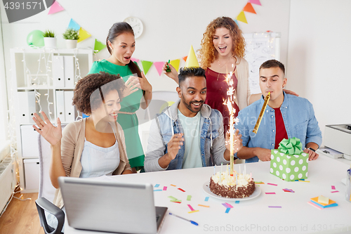 Image of office team greeting colleague at birthday party