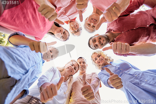 Image of happy family showing thumbs up