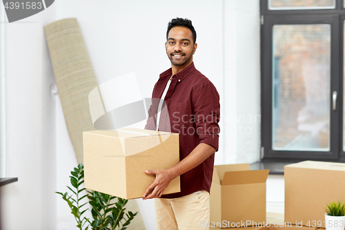 Image of happy man with box moving to new home