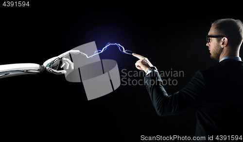 Image of robot and businessman connected by lightning