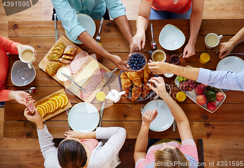 Image of group of people having breakfast at table