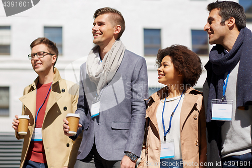 Image of office workers with coffee on city street