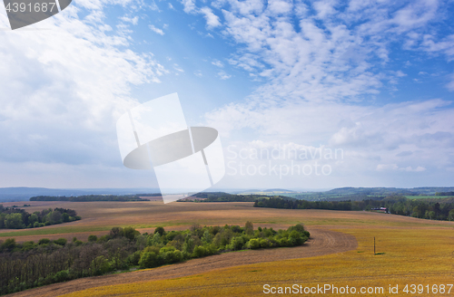 Image of Spring landscape with field, forest and sky