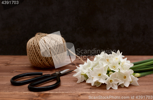 Image of Ball of twine with scissors and white narcissi blooms