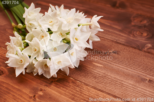 Image of Fresh bouquet of white narcissus flowers on a wooden table