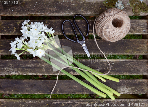 Image of Ball of twine and scissors with bunch of white narcissi