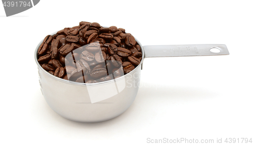 Image of Roasted coffee beans in a cup measure