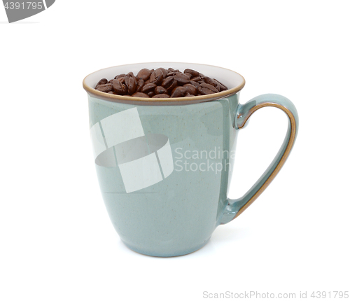 Image of Green mug filled with dark roasted coffee beans