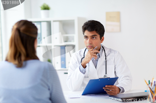 Image of doctor with clipboard and patient at hospital