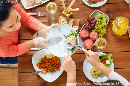 Image of women eating chicken for dinner