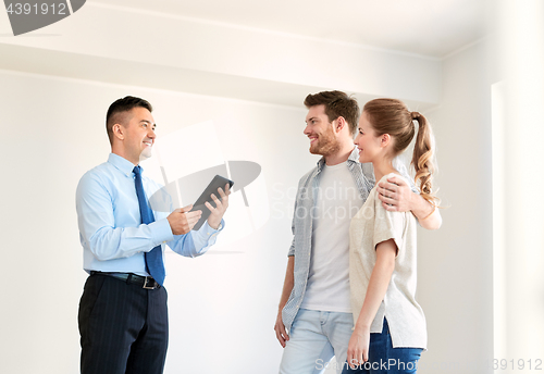 Image of couple and realtor with tablet pc at new home