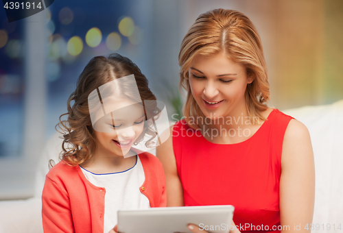 Image of mother and daughter with tablet pc at home