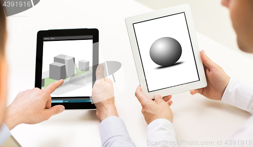 Image of designers with 3d models on tablet pc screens