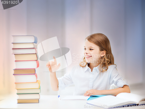 Image of happy smiling student girl counting books