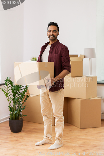 Image of happy man with box moving to new home and dancing