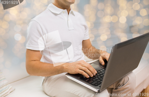 Image of close up of man typing on laptop keyboard
