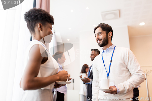 Image of business people with conference badges and coffee