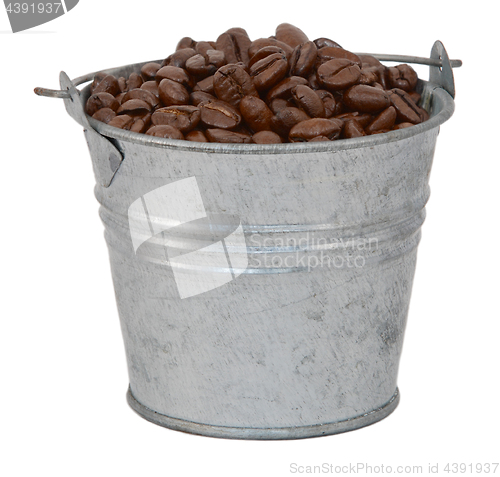 Image of Dark roasted coffee beans in a metal bucket