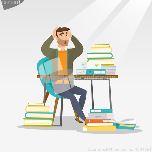 Image of Student sitting at the table with piles of books.