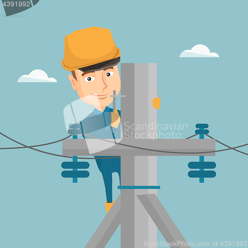 Image of Electrician working on electric power pole.