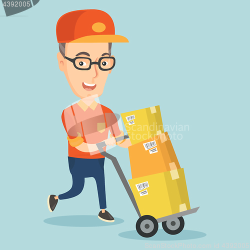 Image of Delivery postman with cardboard boxes on trolley.