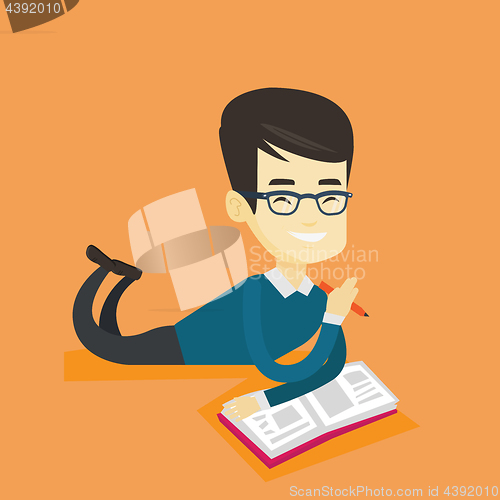 Image of Student laying on the floor and reading book.