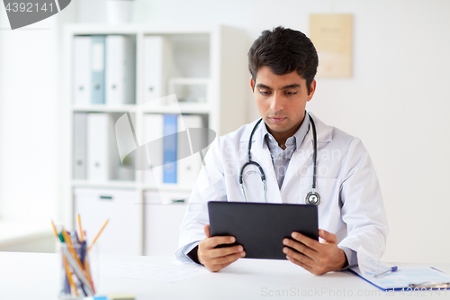 Image of doctor with tablet pc and stethoscope at clinic