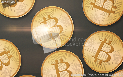 Image of gold bitcoins over gray background from top