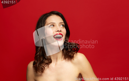 Image of beautiful smiling young woman with red lipstick