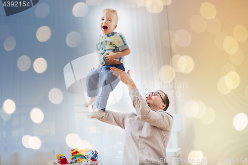 Image of father with son playing and having fun at home