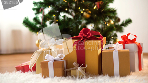 Image of gift boxes on sheepskin at christmas tree