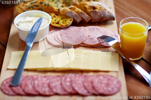 Image of cream cheese and other food on table at breakfast