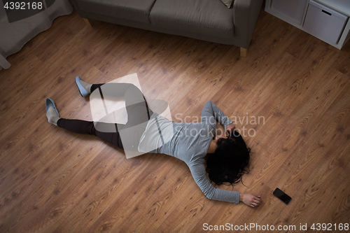 Image of dead woman body lying on floor at crime scene