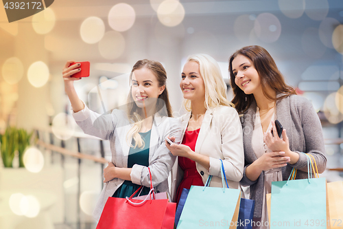 Image of women with smartphones shopping and taking selfie